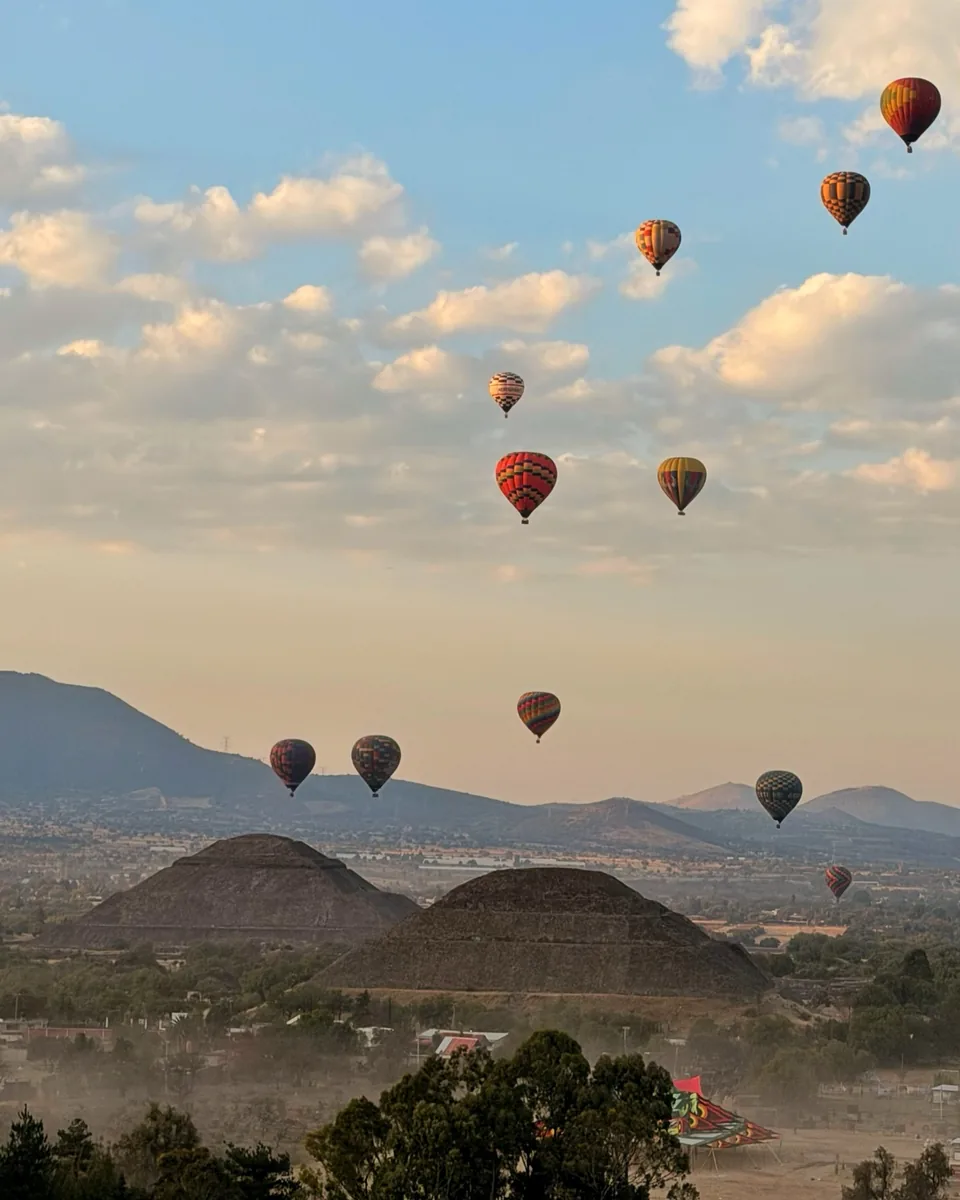 Hot air balloons and morning clouds over the Teotihuacan valley
