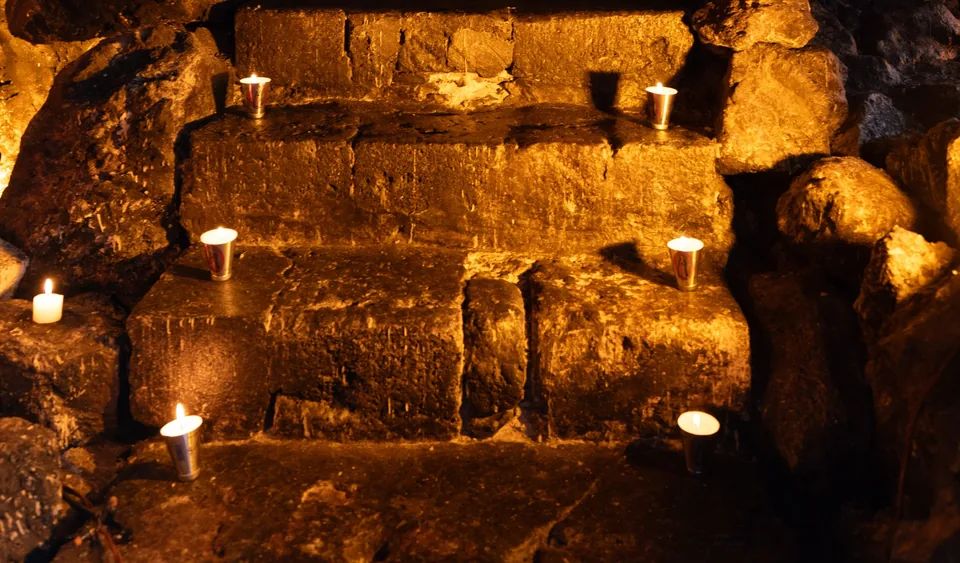 Candles set into the stone steps inside La Gruta Teotihuacan