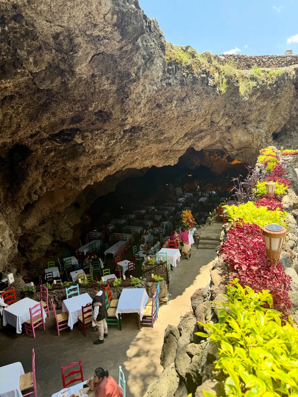 The entrance to La Gruta lined with flowers and greenery