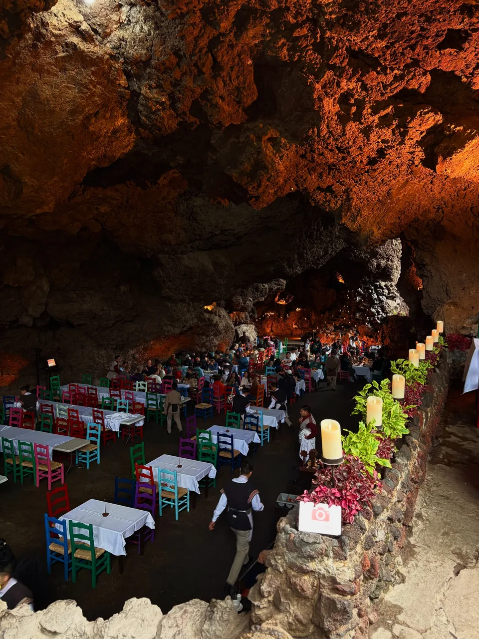 The dining room at La Gruta lit by candles inside the grotto